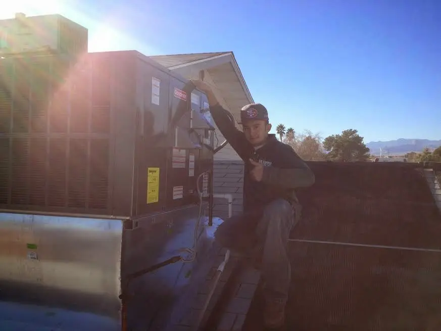 HVAC technician performing HVAC Inspection on a rooftop unit in Delaware